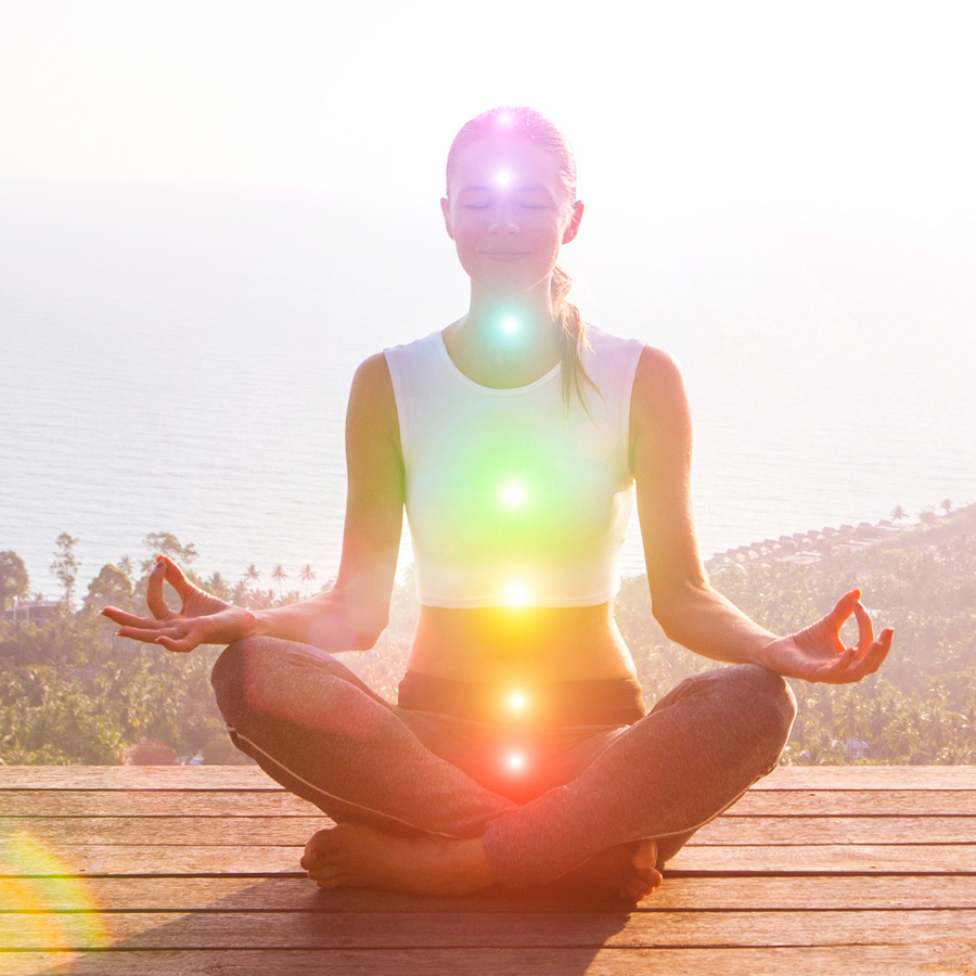 Woman meditating and aligning her chakras