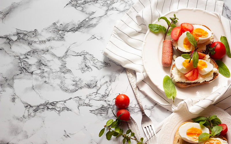 Breakfast served on a marble dining table.