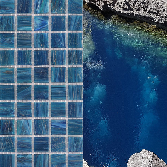 Close-up of blue glass mosaic tiles with ocean photo.