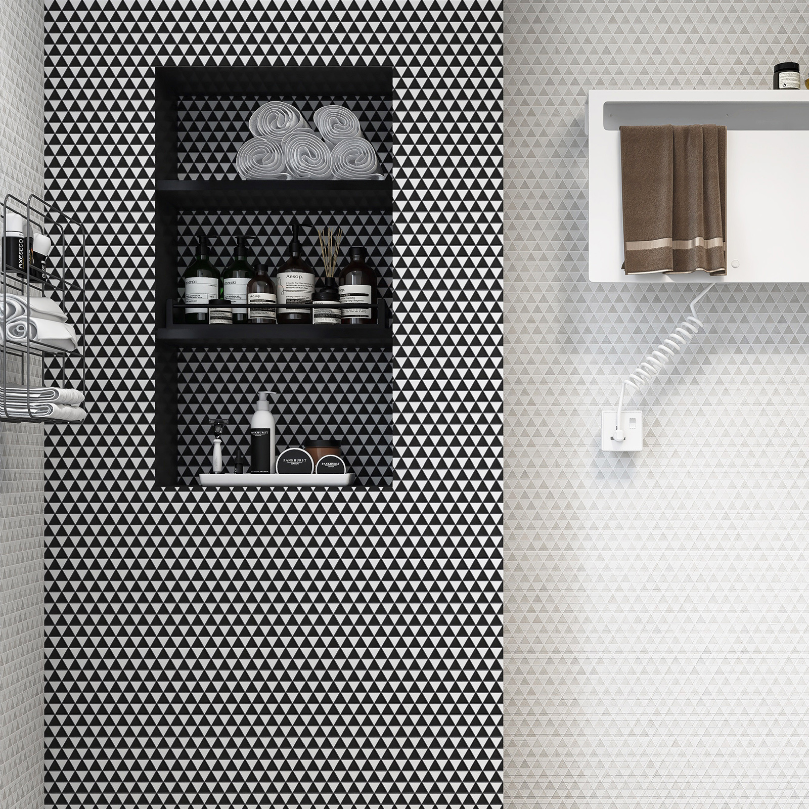 Black and white triangle-shaped mosaic tiles on bathroom wall and niche.