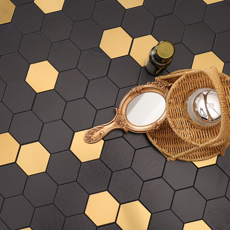 Black and gold hexagon mosaic tiles on the floor with gold accents, cosmetics, and a mirror.