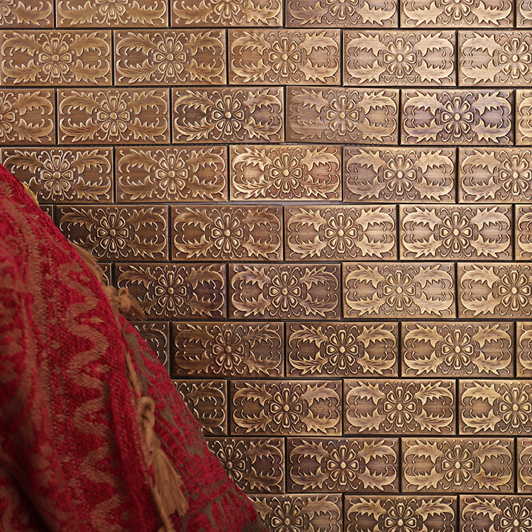Rectangular brick metal mosaic tiles in bronze with embossed patterns.