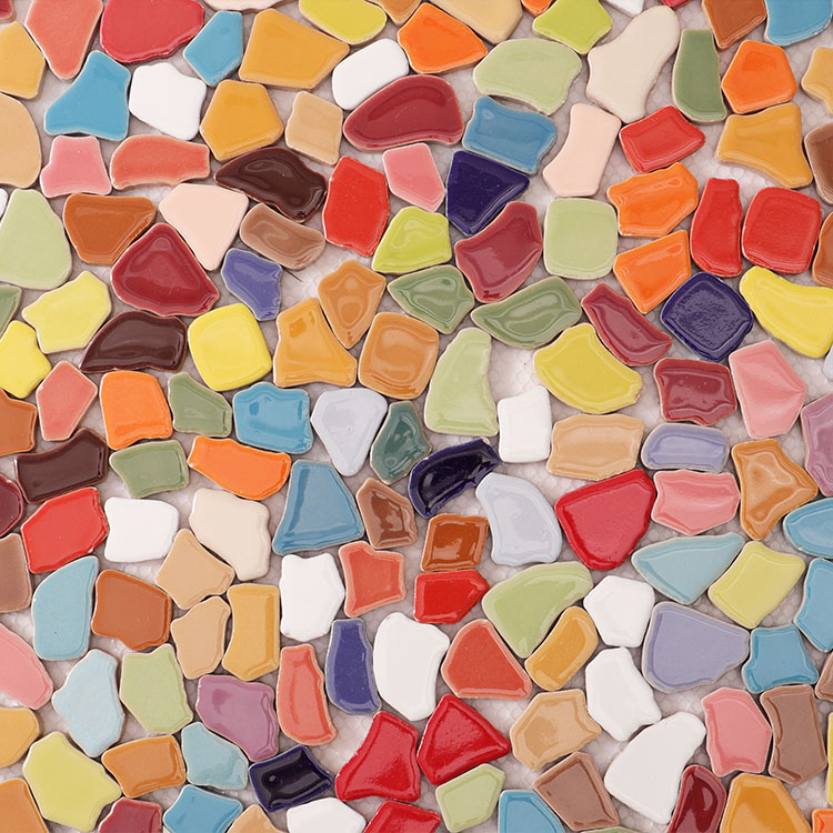 Front view of mosaic tiles made from many colored ceramic fragments.