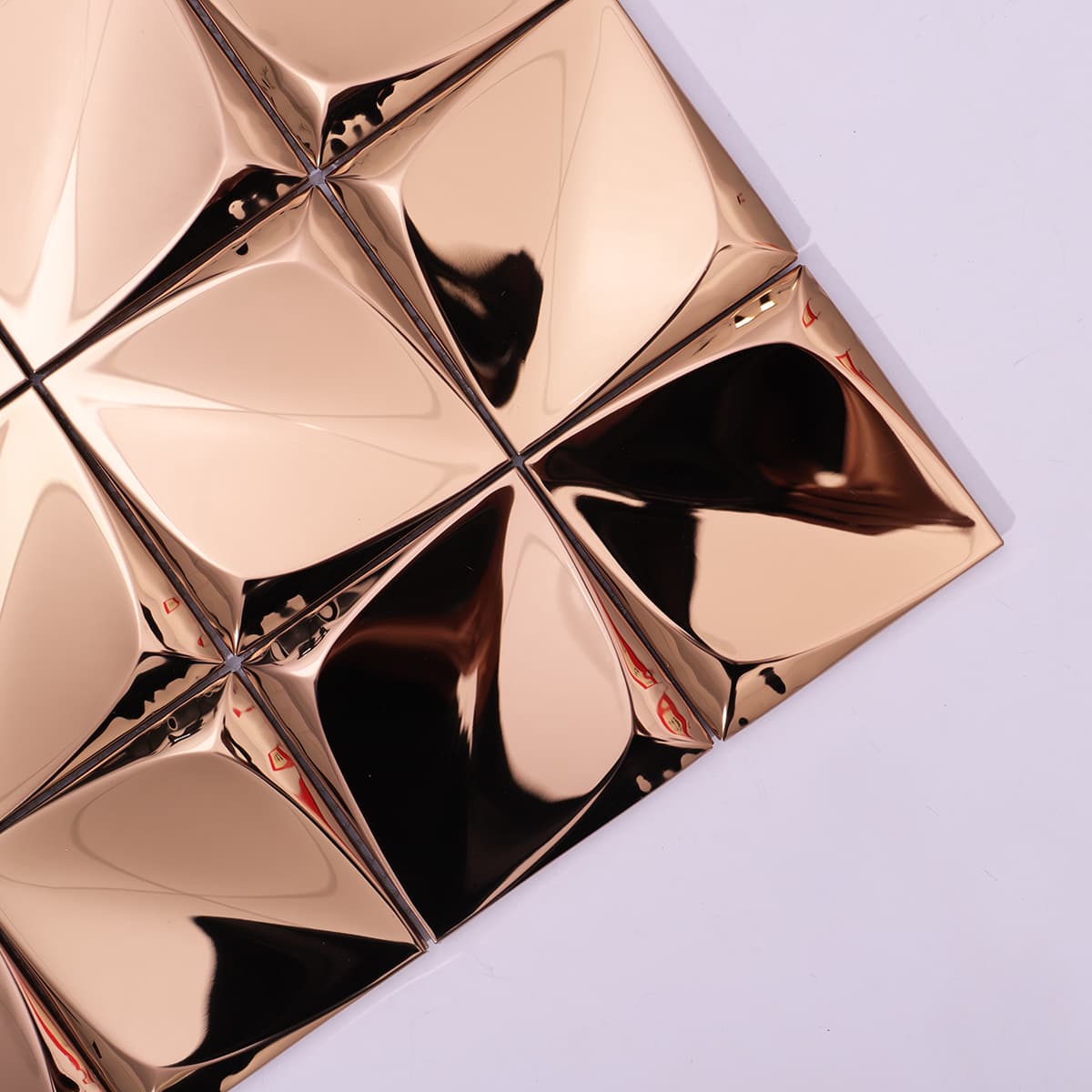 Corner view of rose gold 3D pyramid metal mosaic tiles