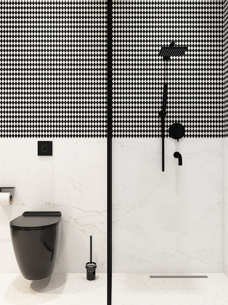 Black and white diamond mosaic half-wall with glass partition between shower and toilet.
