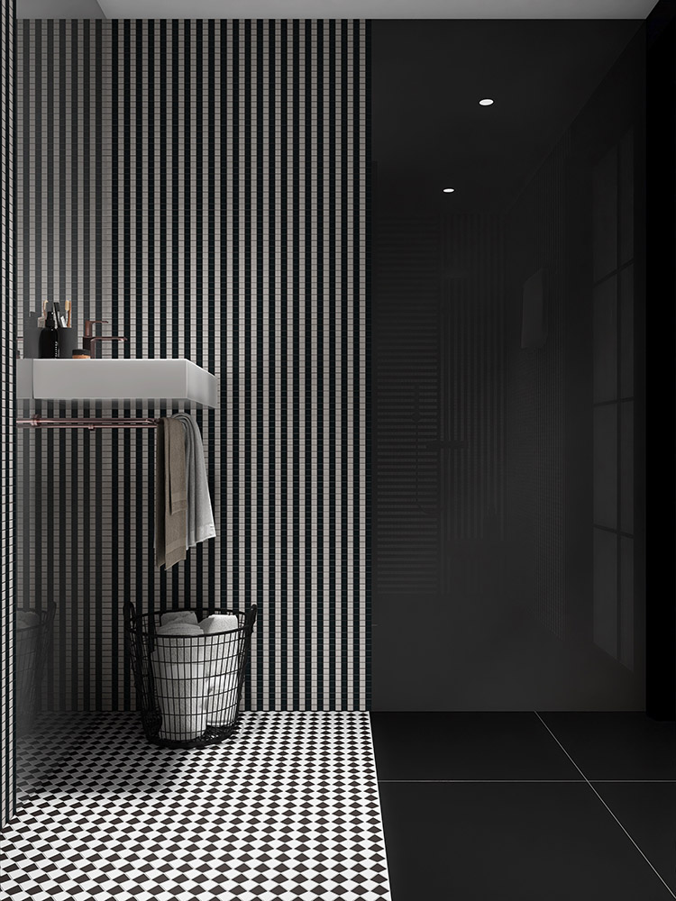 Black and white striped mosaic tile wall partially paired with a gray mirrored wall.