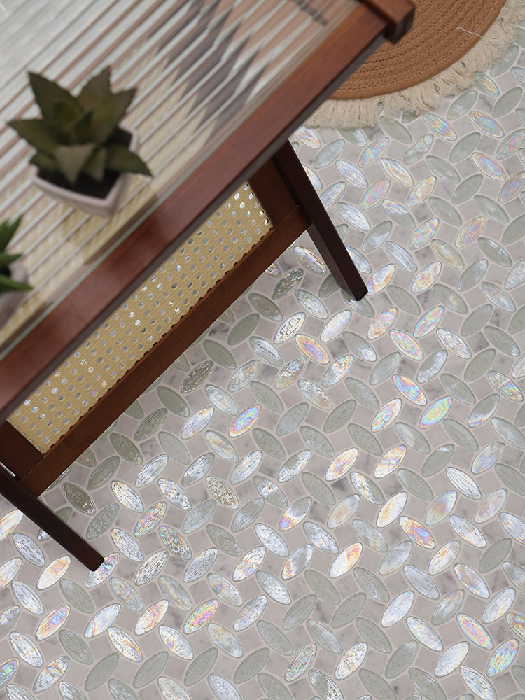 White glass iridescent oval mosaic tiles and white marble on the floor.