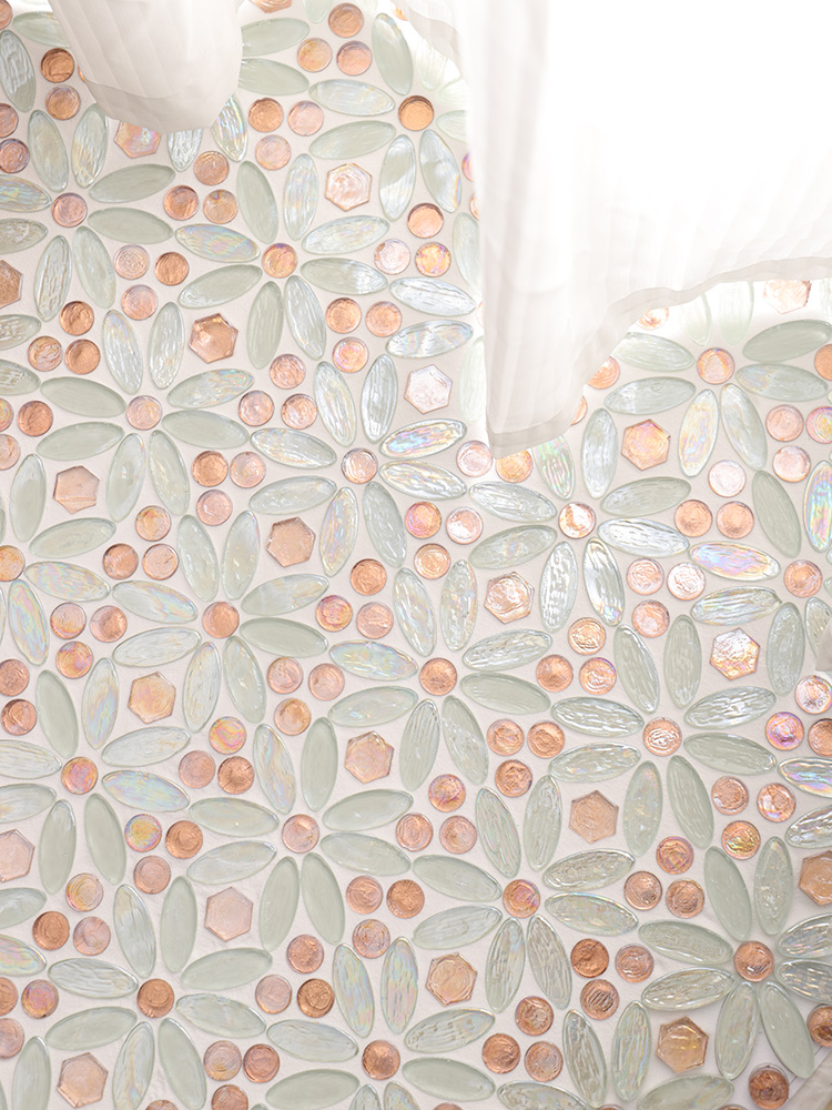 The combination of iridescent white and rose gold glass mosaic tiles creates a chic and elegant touch to the bedroom floor, beautifully complemented by soft white curtains.