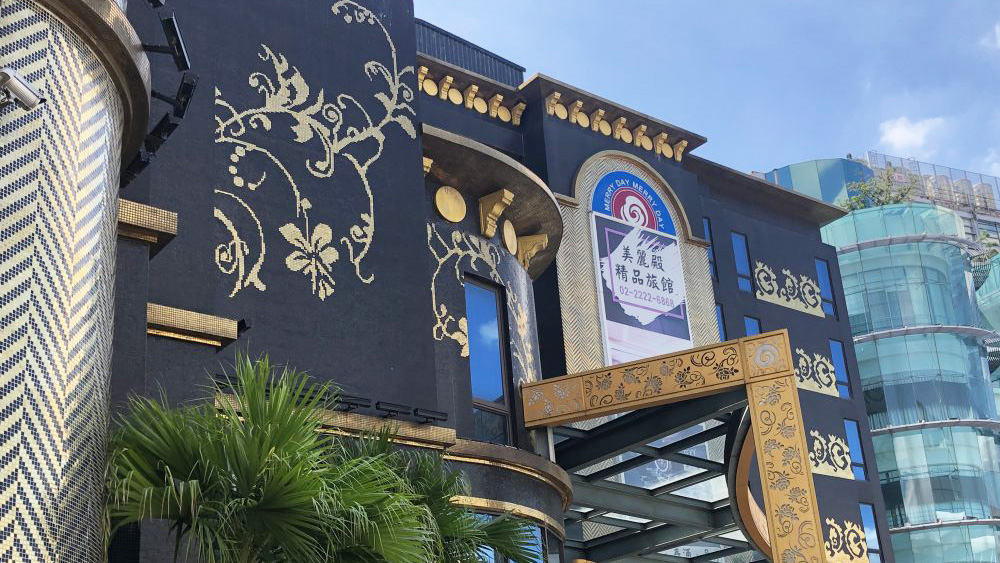Gold pattern on black background mosaic tiles at the hotel entrance.
