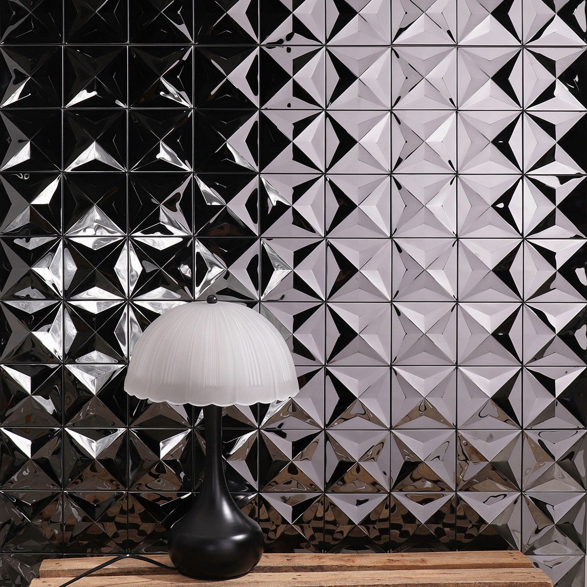 Black 3D mirror metallic mosaic tiles on a living room wall.