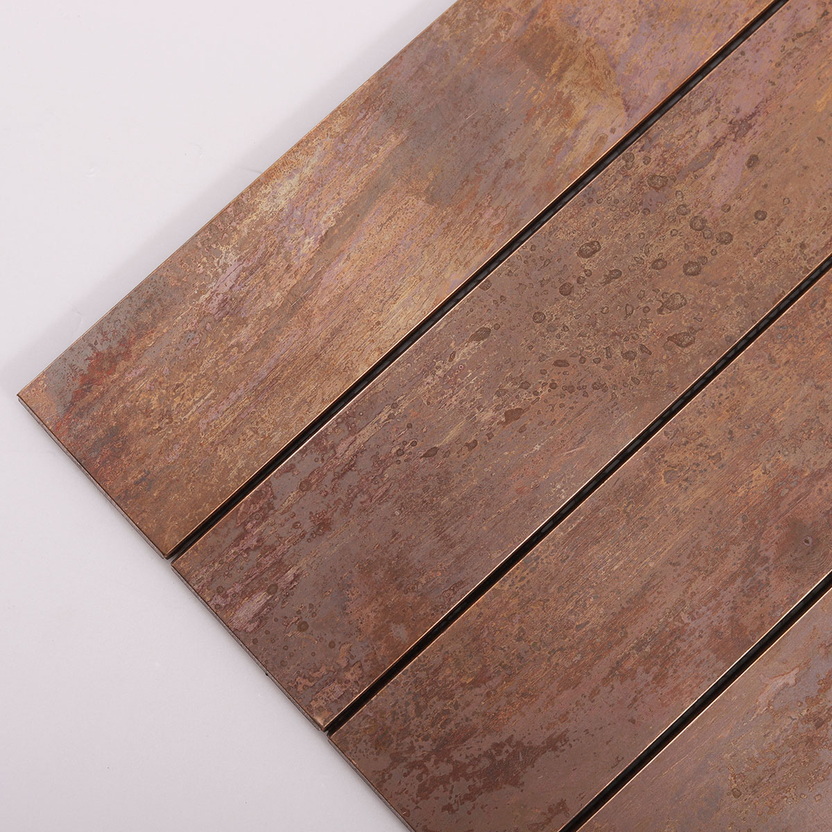 Close-up view of copper rust matte brick metal mosaic tiles.