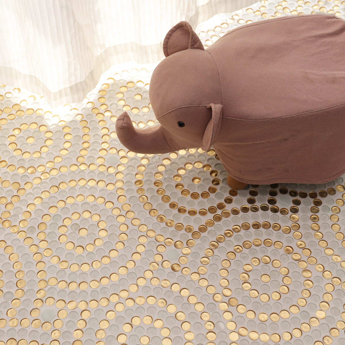  Floor scene featuring the gold and white circular mosaic tiles laid out