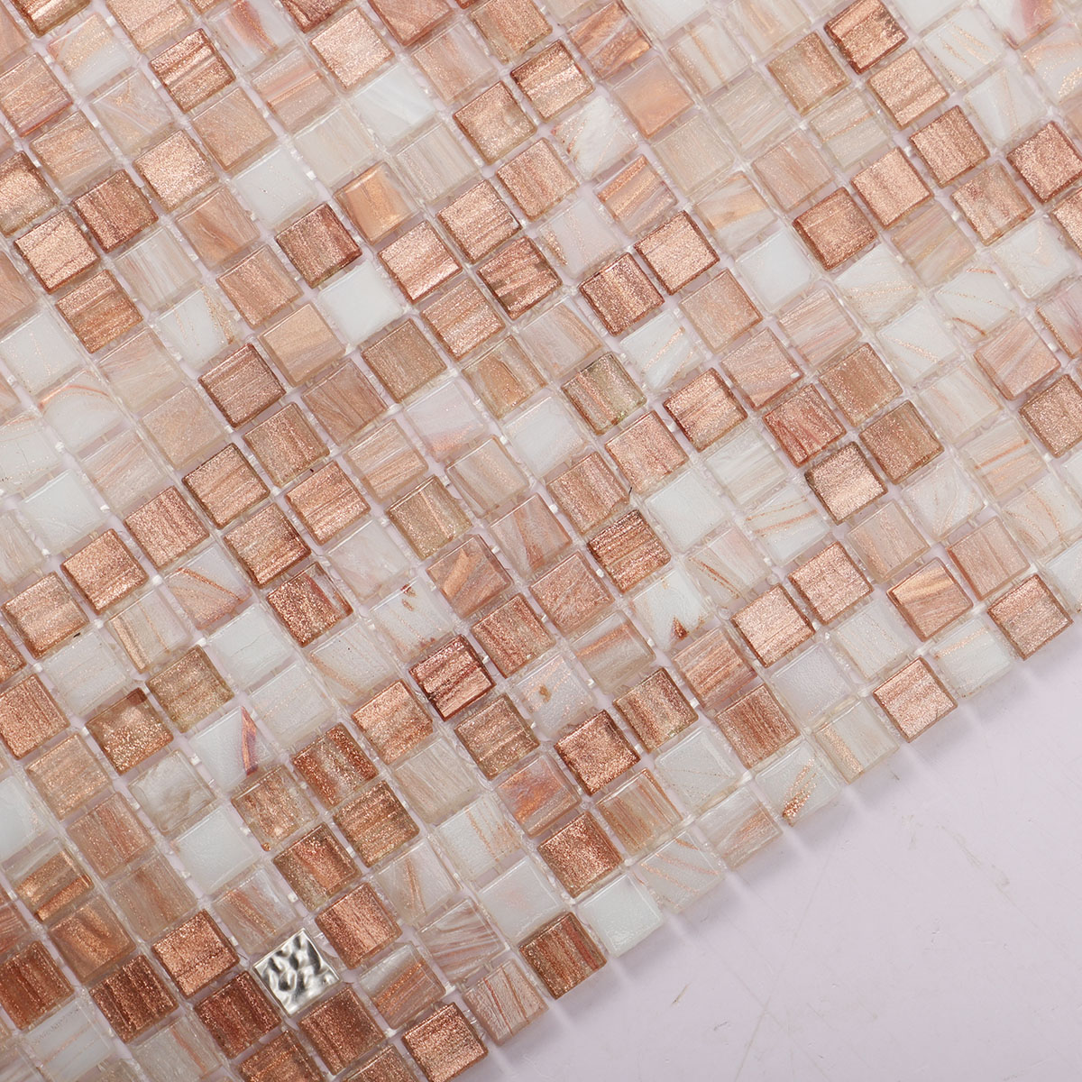 Close-up view of mini square glass mosaic tile with 24K platinum.