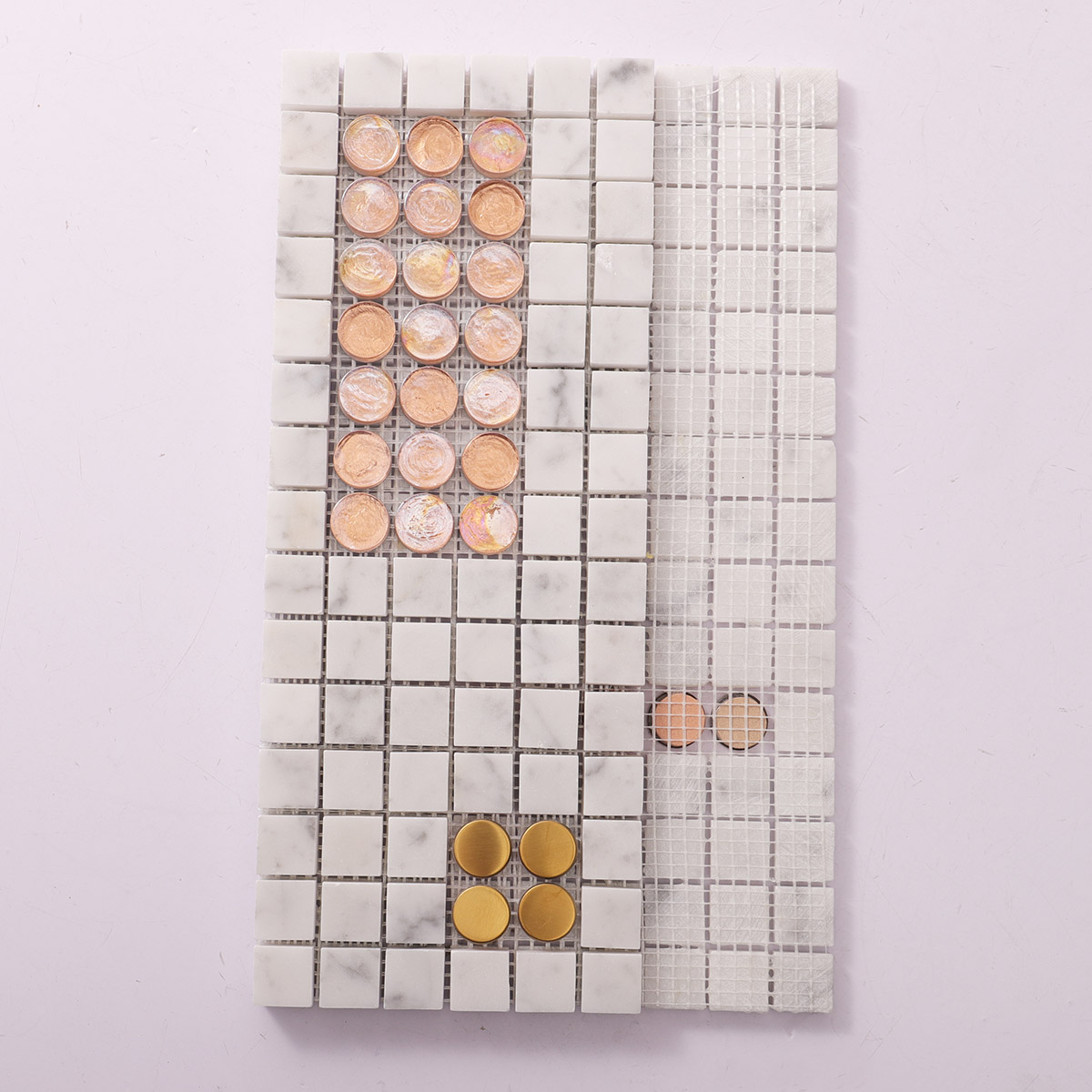 Back side of white marble mixed with glass and metal mosaic tiles, showing fold