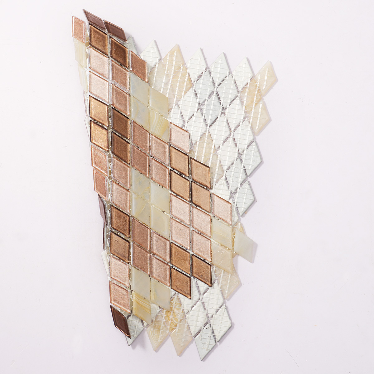 Back side of beige diamond-patterned glass mosaic tiles, showing fold.