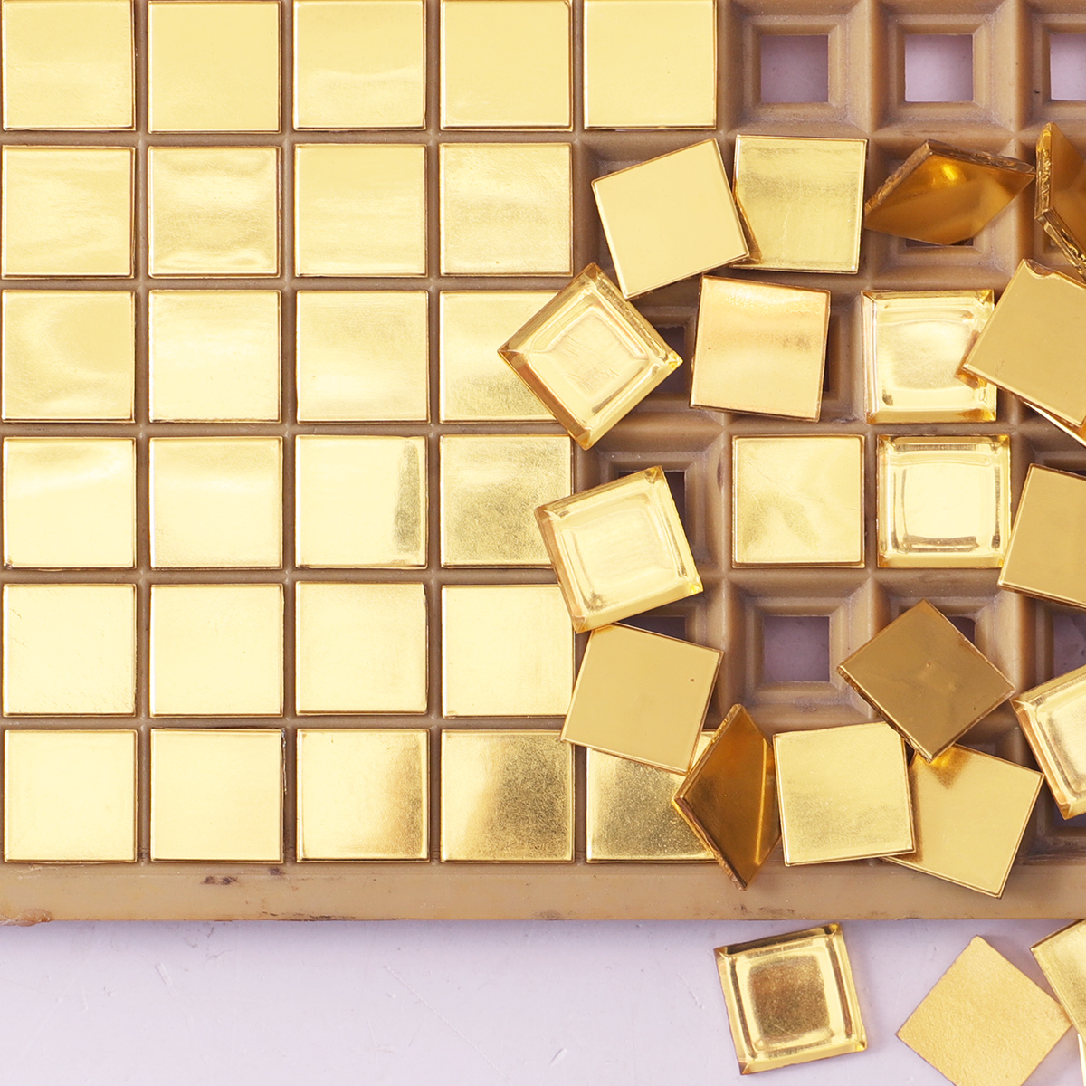 Close-up of 24K gold mirror square glass mosaic tiles