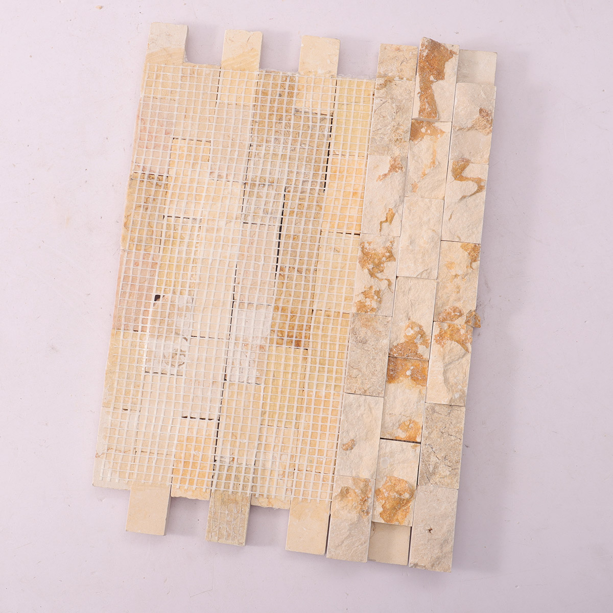 Folded back side of Crema Marfil face stone mosaic tiles.