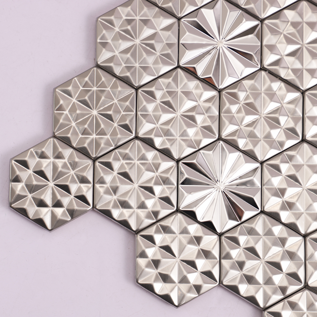 Detailed close-up of silver hexagon 3D metal mosaic tiles.