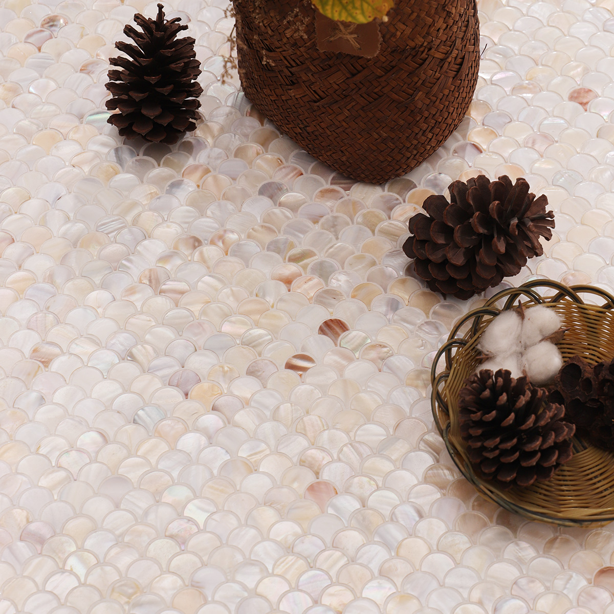 Close-up of beige mini fish scale mother of pearl mosaic tiles with natural texture.