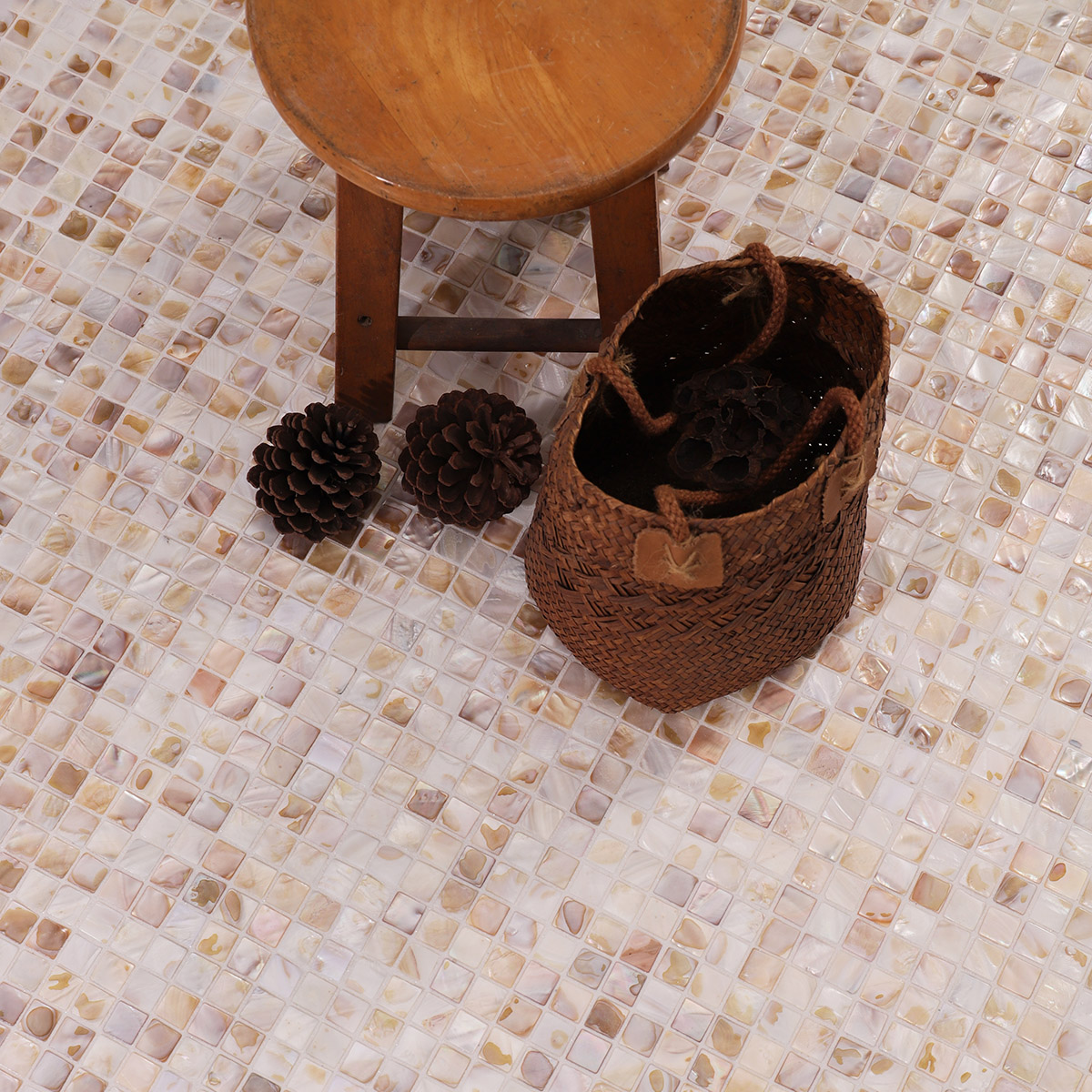 Close-up of beige mini fish scale mother of pearl mosaic tiles with a glossy shine.