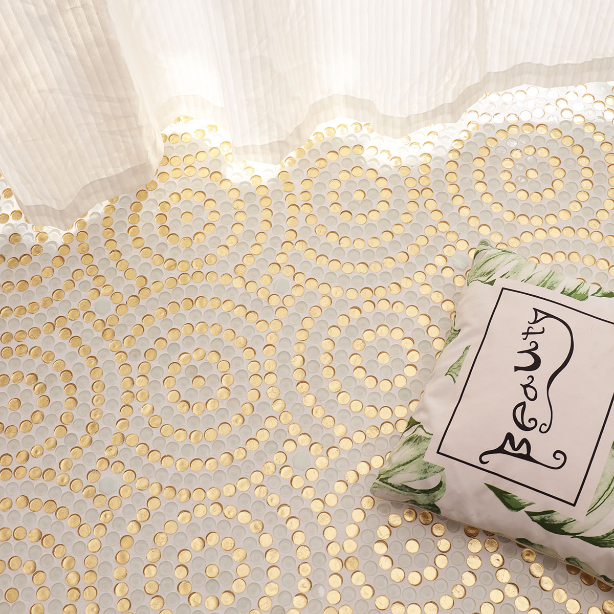 Bedroom floor scene featuring circular gold and white mosaic tiles