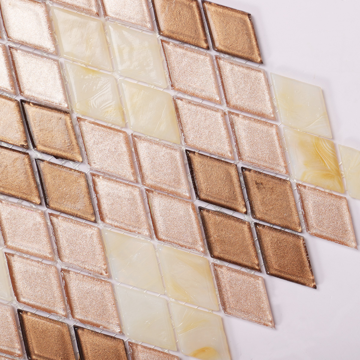 Third close-up of beige diamond-patterned glass mosaic tiles.