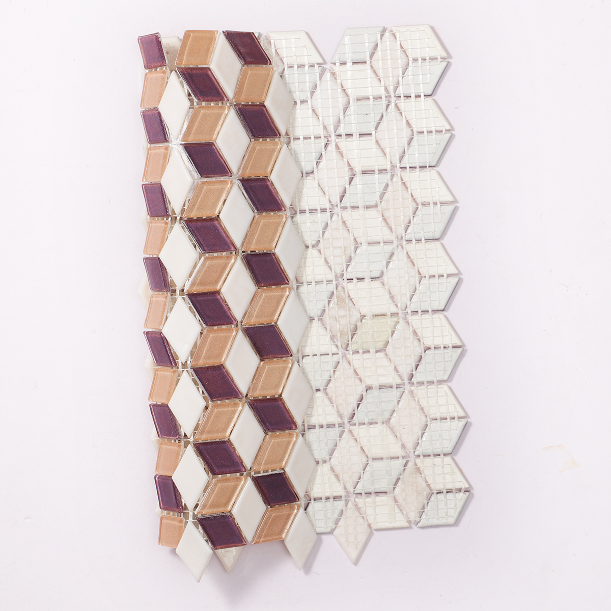 Back side of pink and purple diamond-shaped glass mosaic tiles, showing fold.