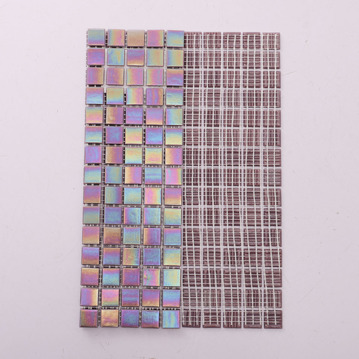 Back side of purple rainbow glass mosaic tiles, showing fold and mesh mounted