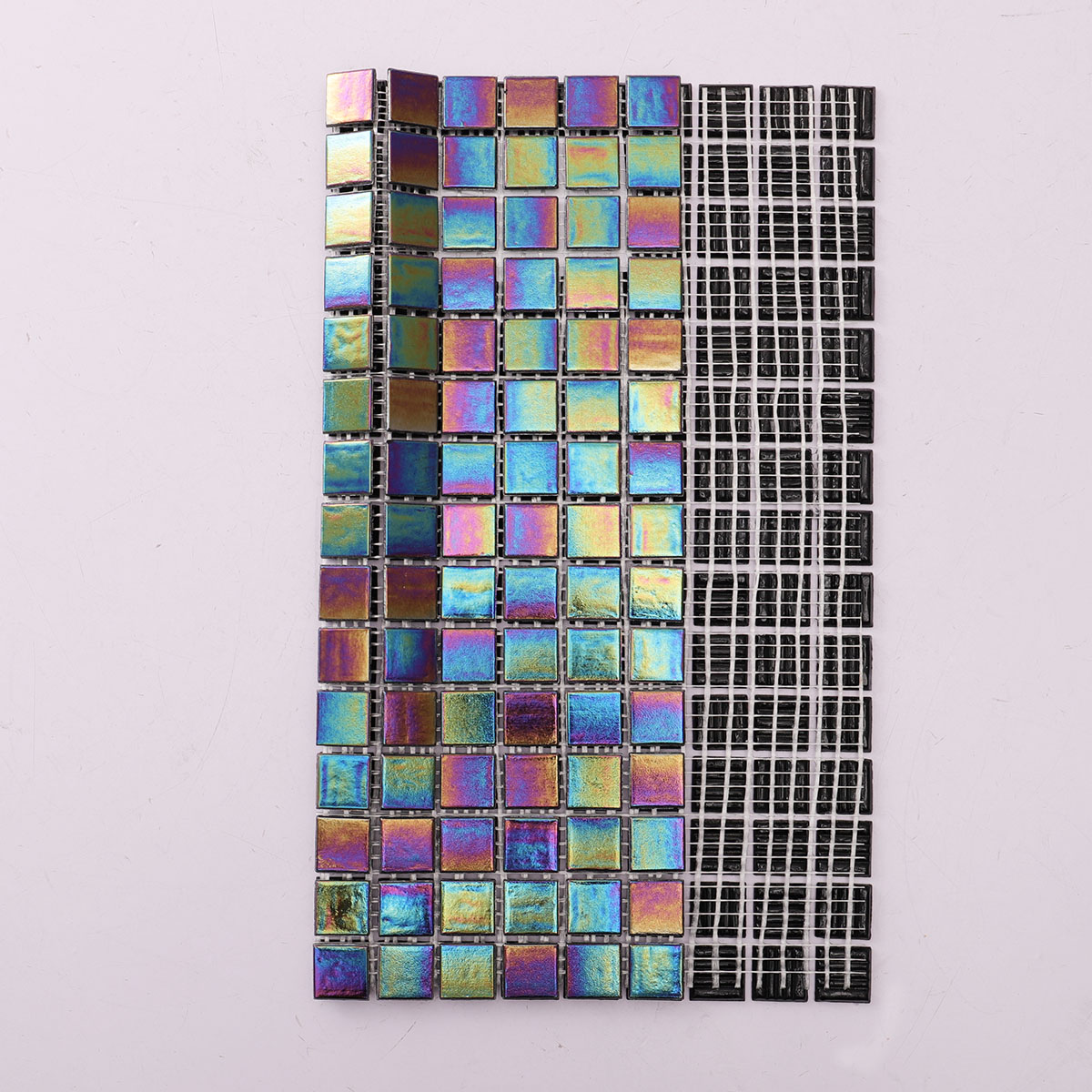 Folded back side of multicolor iridescent square glass mosaic tiles on mesh