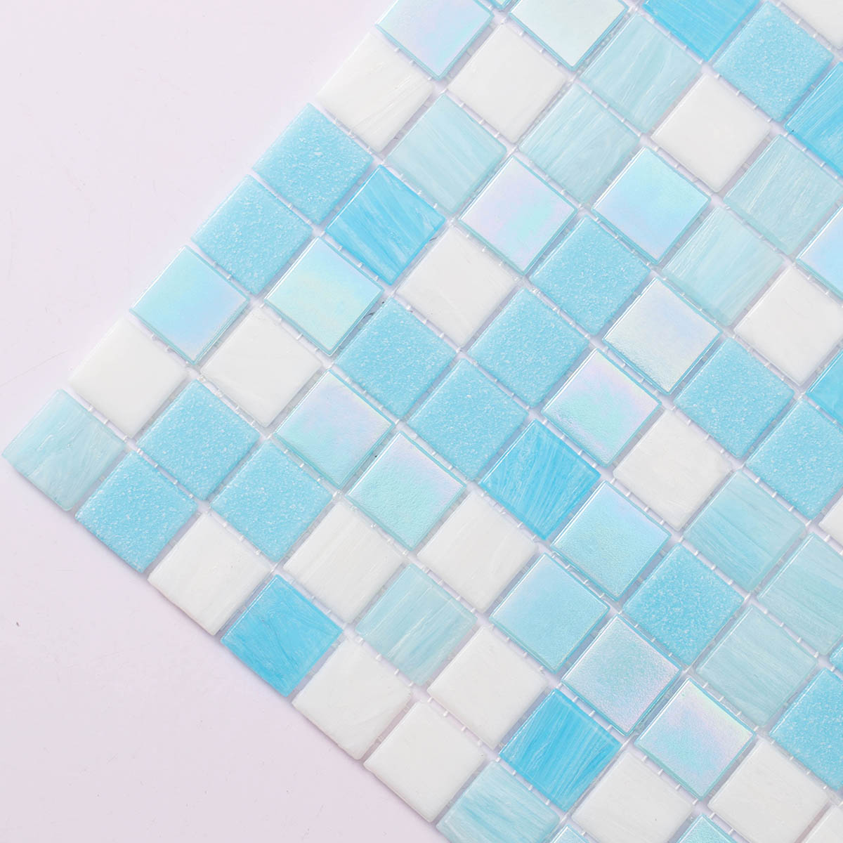 Close-up side view of glossy aqua blue glass mosaic tiles