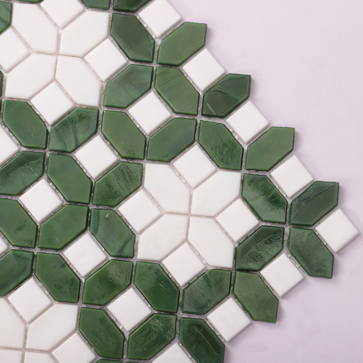 Detailed close-up of white and green picket glass mosaic tile