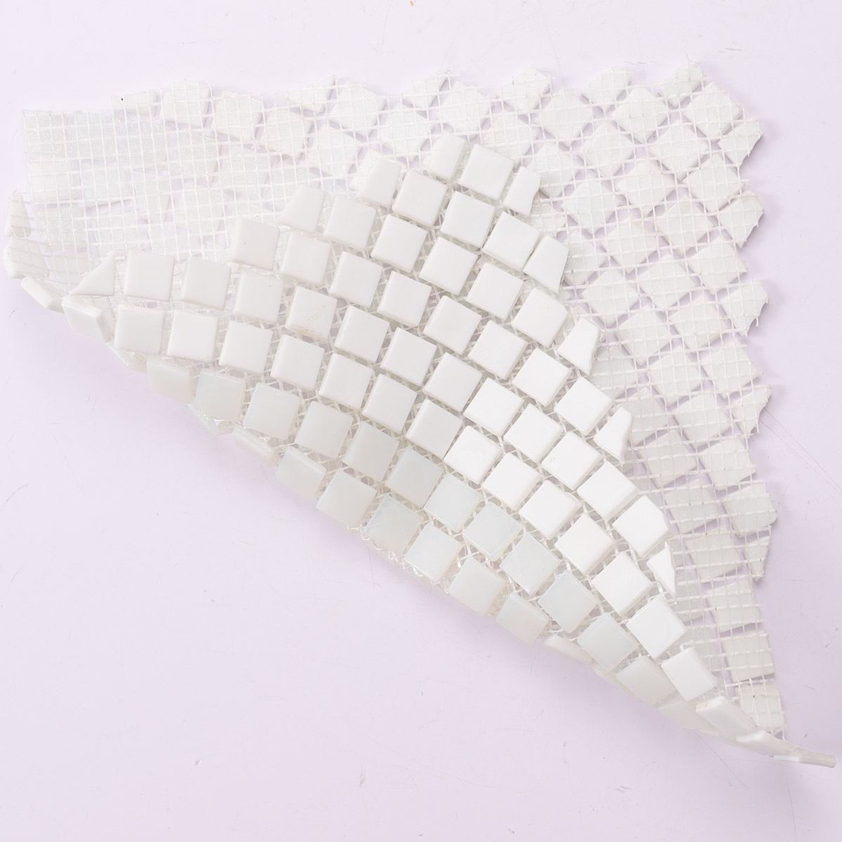 Folded view of back side of white glass mosaic art patterns
