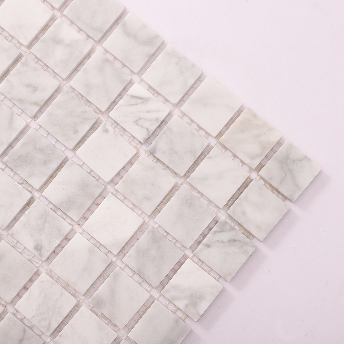 Close-up of White Carrara square marble mosaic stone tile