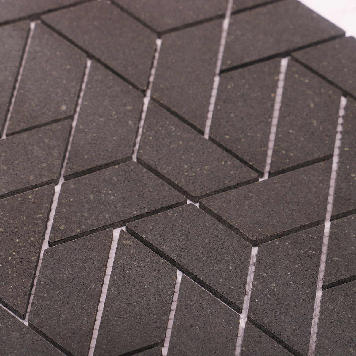 Close-up view of black marble mosaic bathroom floor tiles