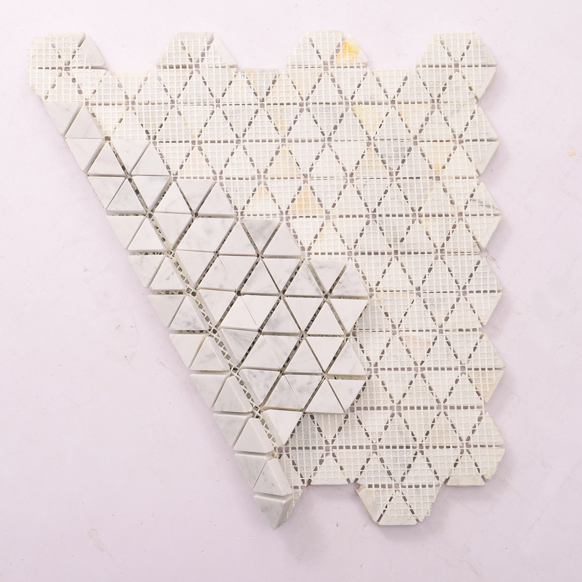 Folded back side of Carrara white geometric triangle marble mosaic tiles.