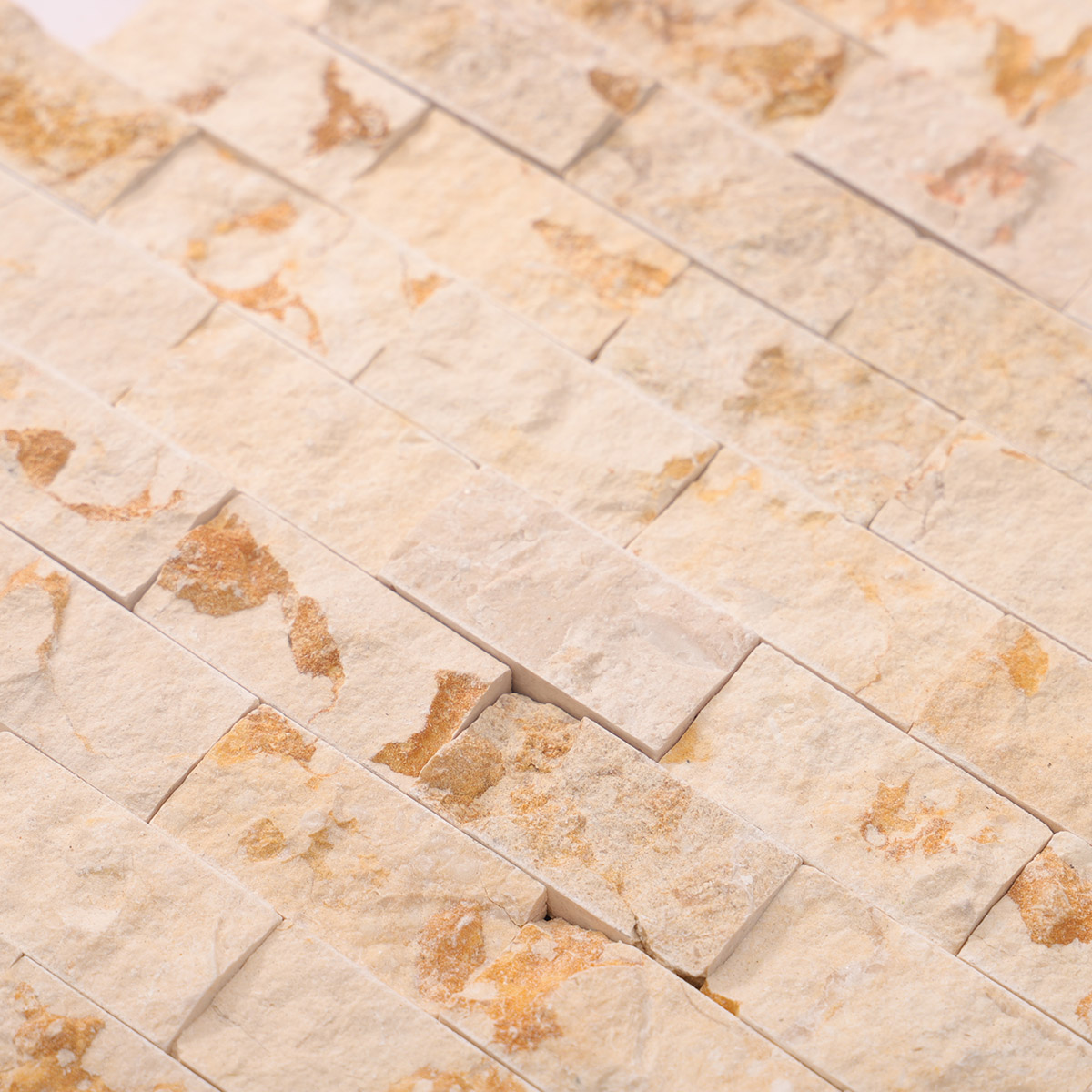 Close-up of Crema Marfil face stone mosaic tiles.