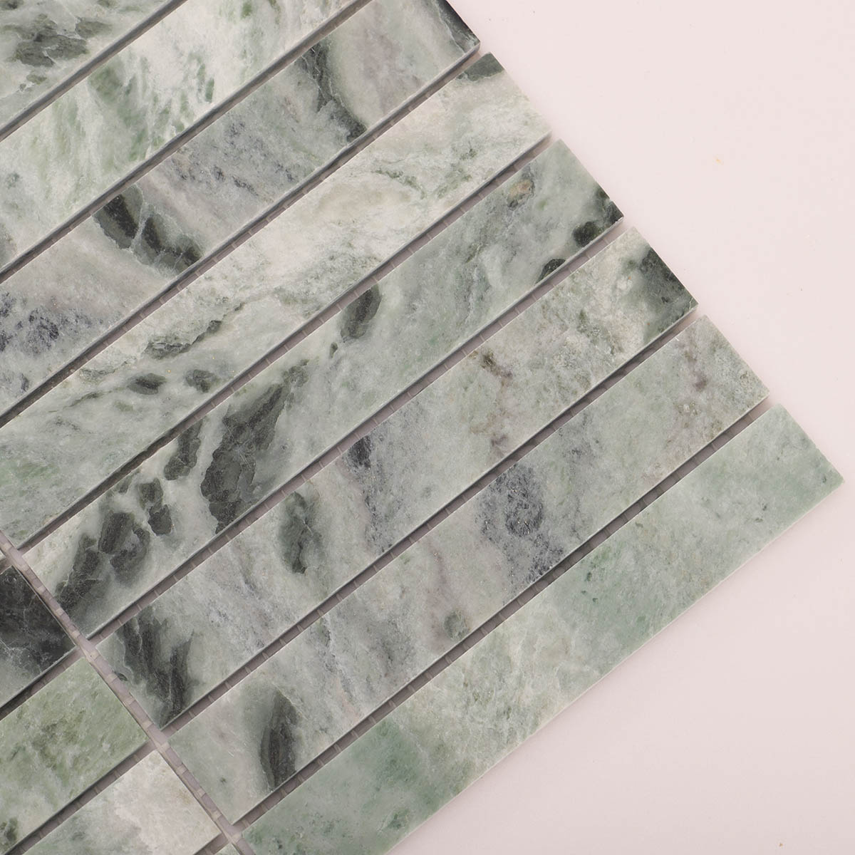 Detailed close-up of emerald green marble polished vertical mosaic tiles.