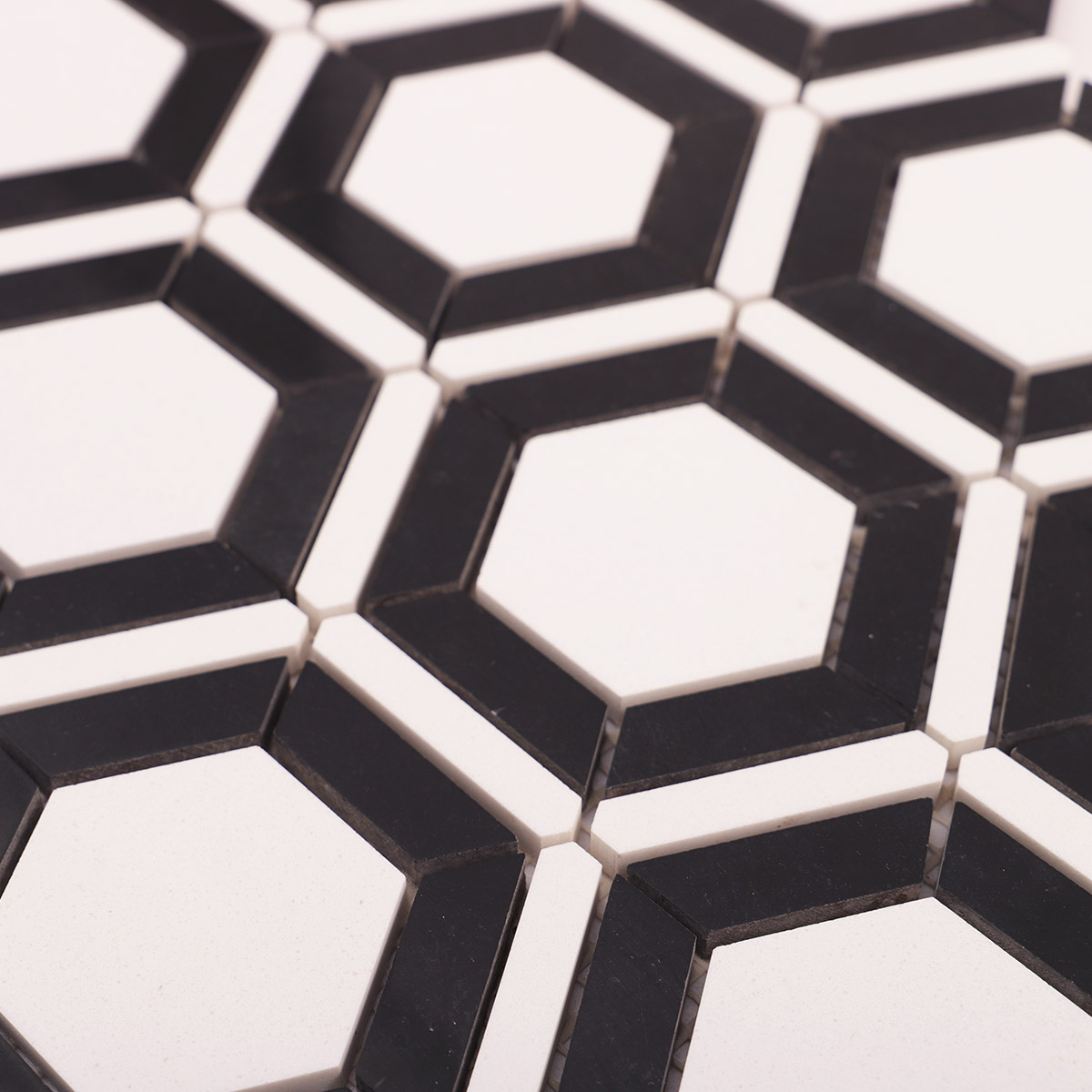 Close-up view of white and black hexagon marble mosaic tiles