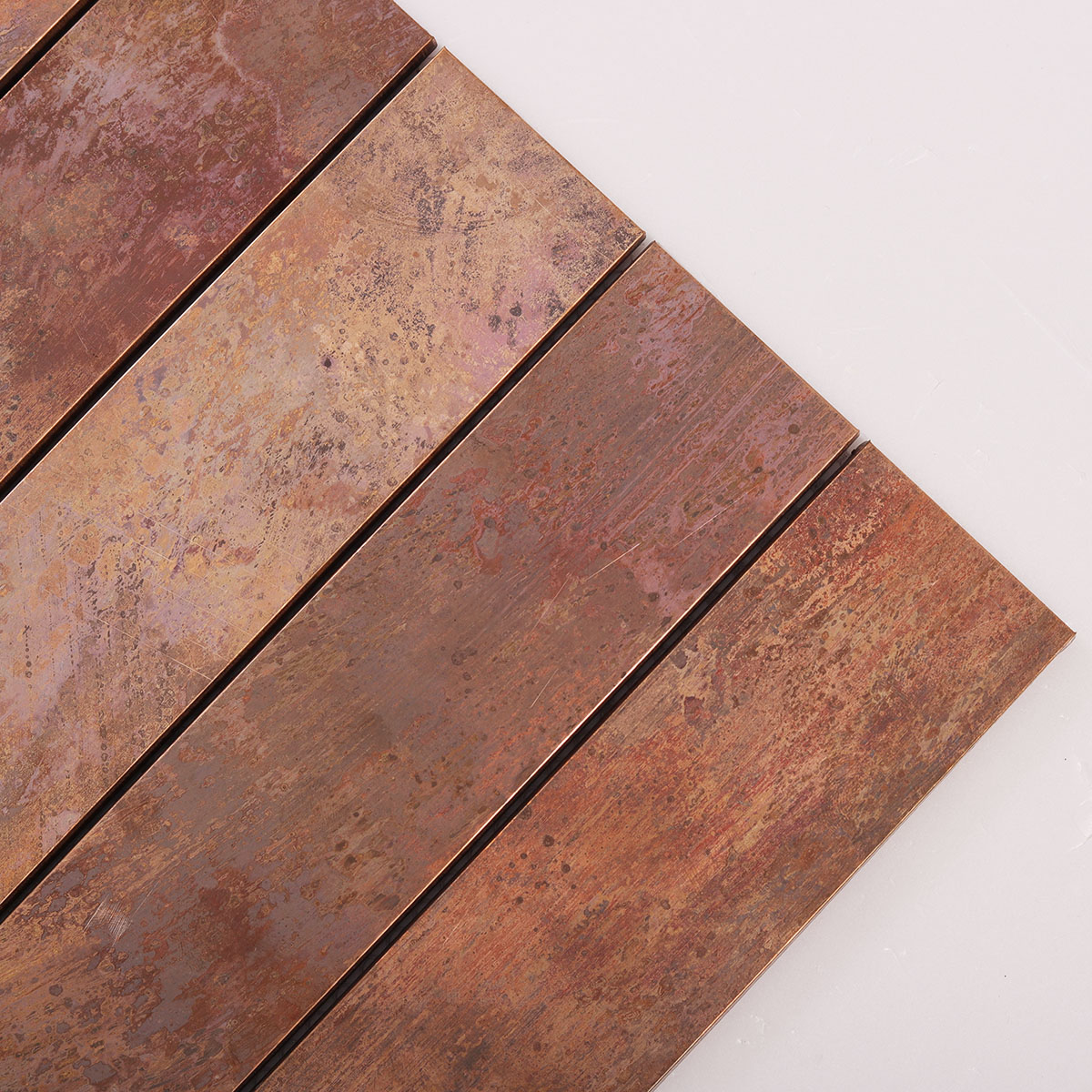 Detailed close-up of copper rust matte brick metal mosaic tiles.