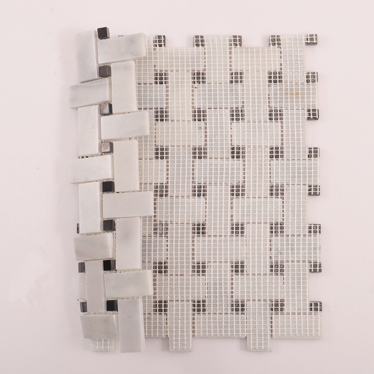 Folded back side of Carrara white basketweave marble mosaic tiles