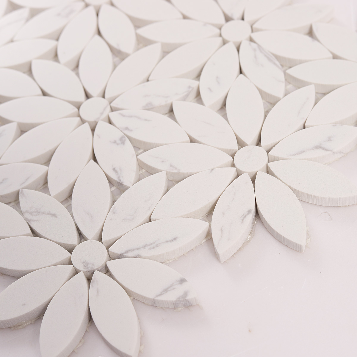 Detailed close-up of white daisy waterjet marble mosaic tiles