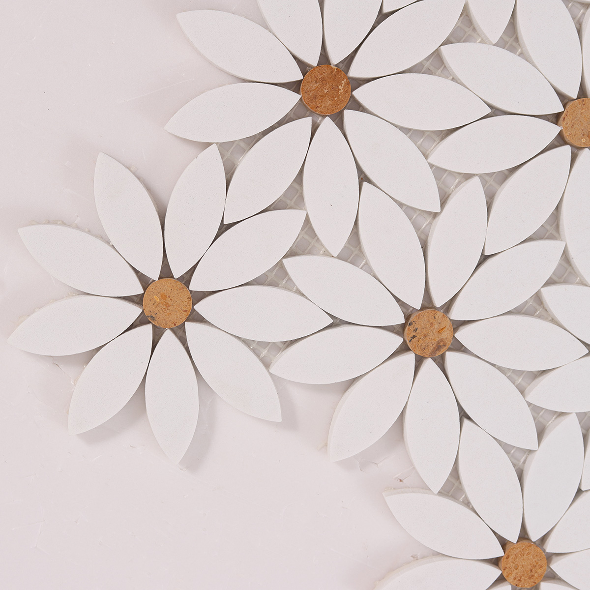 Close-up view of white waterjet sunflower marble mosaic tiles