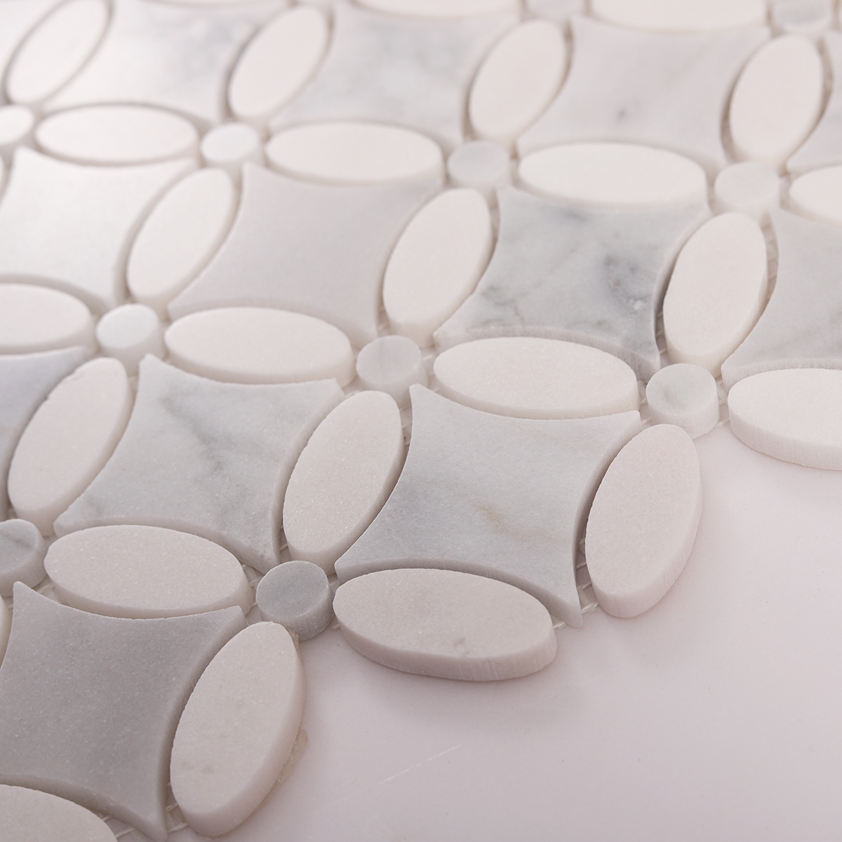 Side close-up view of Carrara white flower marble mosaic tiles, showing texture and thickness.