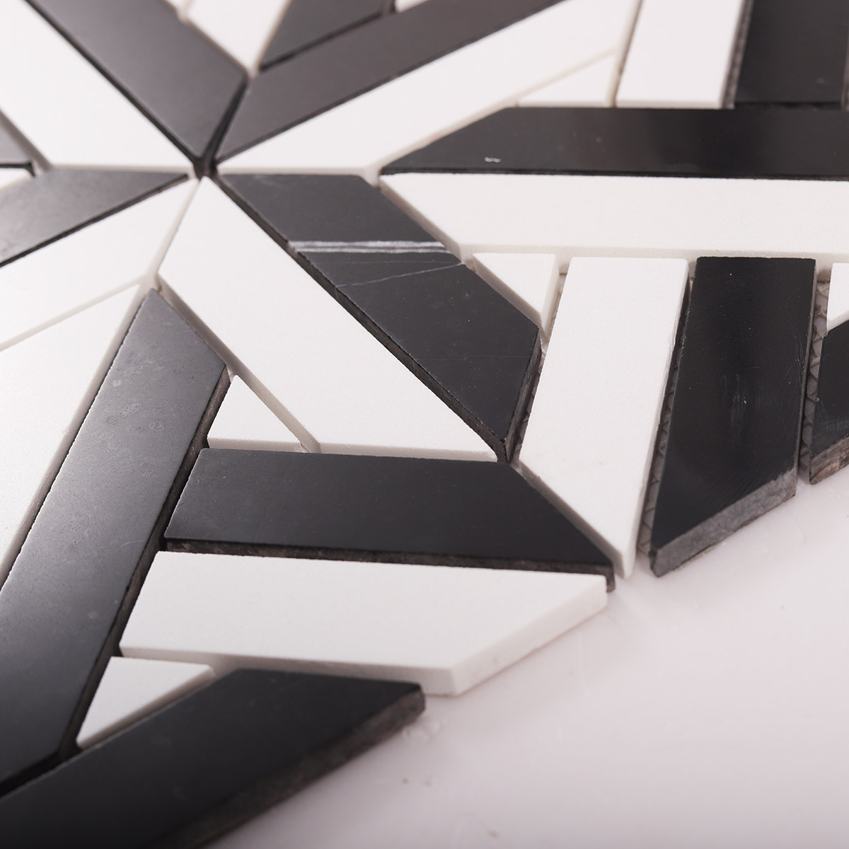 Side close-up view of Geometrica polished marble mosaic tiles, showing texture and thickness