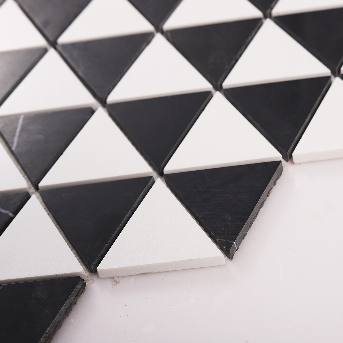 Side close-up view of White and Black Triangle Honed Stone Mosaic Tiles