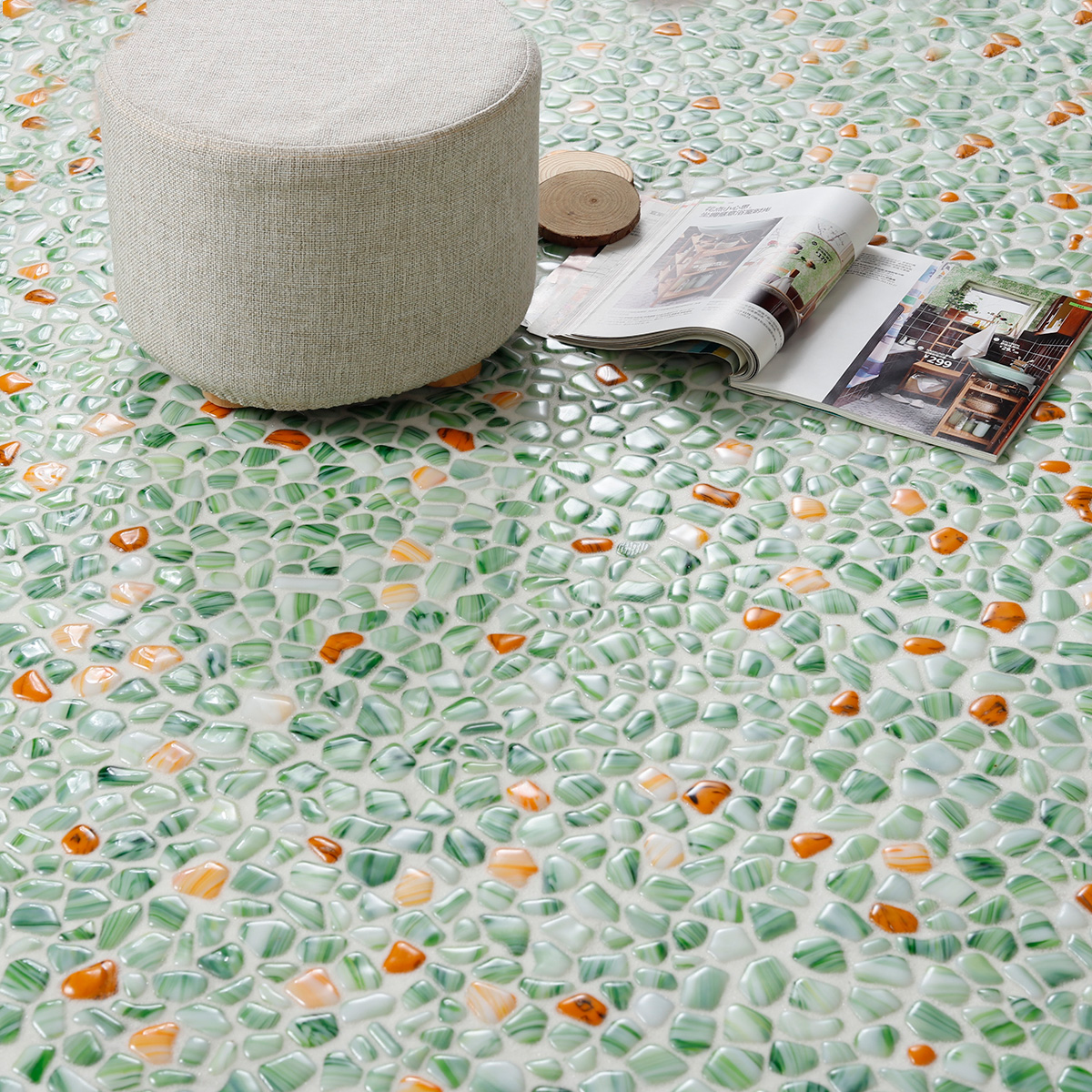 Green glass pebble mosaic tiles resembling river rocks on the floor