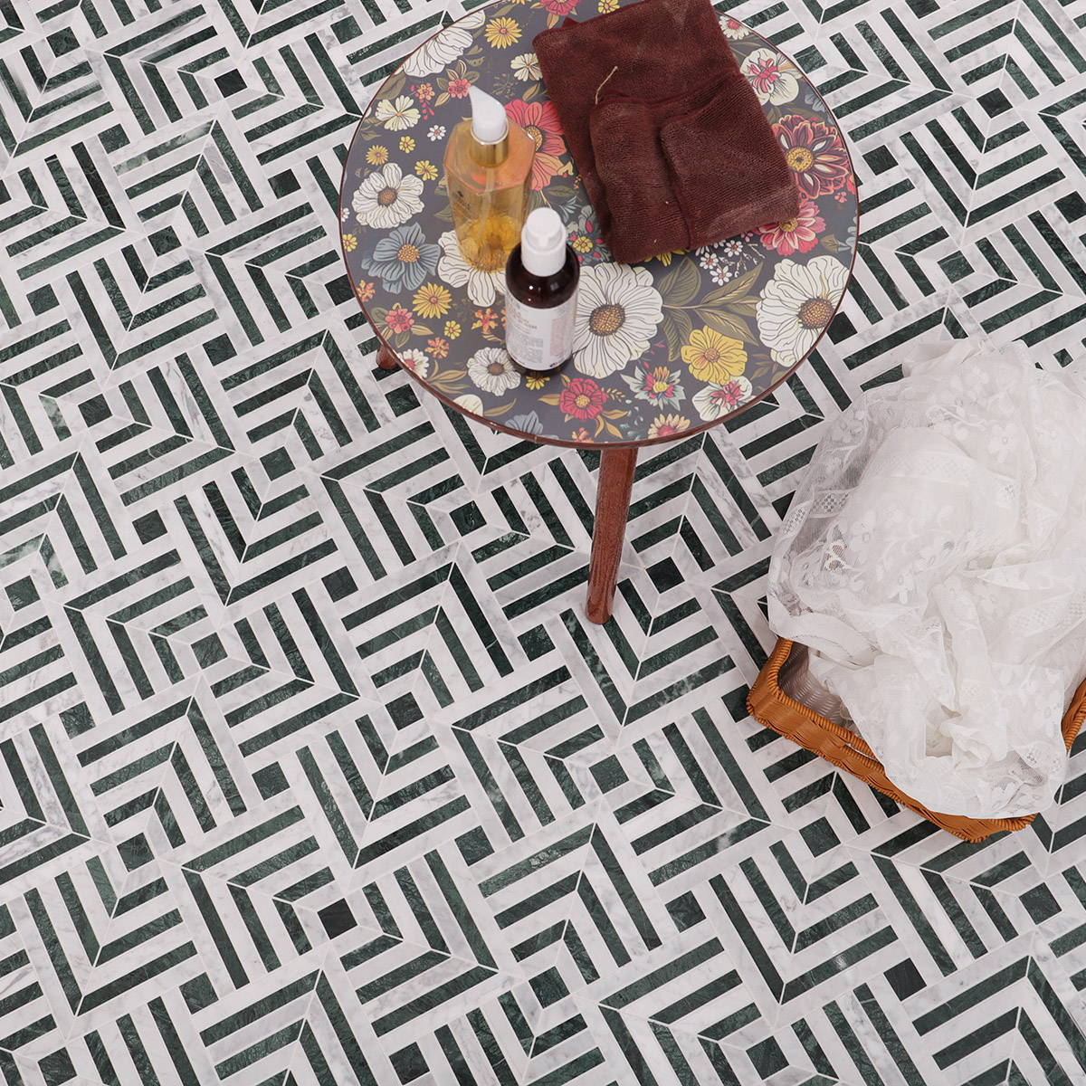 White and green marble chevron pattern mosaic tiles in a home setting with plants and decor.