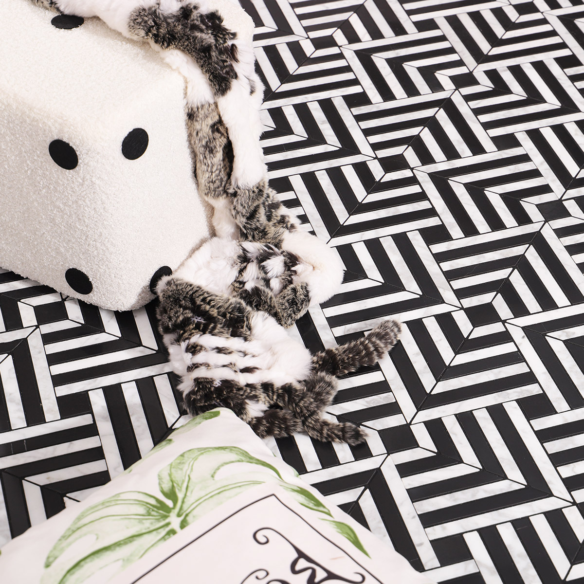 Close-up of black and white mosaic tiles forming a modern geometric pattern on the floor.