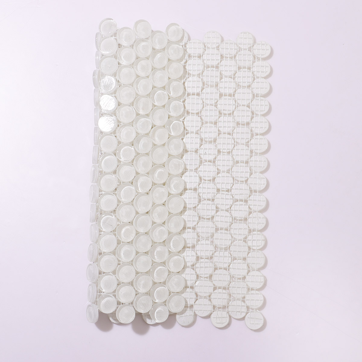 White circular mosaic tiles with mesh backing.