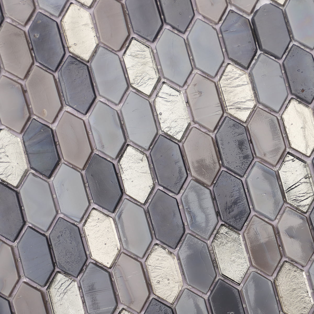 Close-up of a dark gray and metallic mosaic tile arrangement